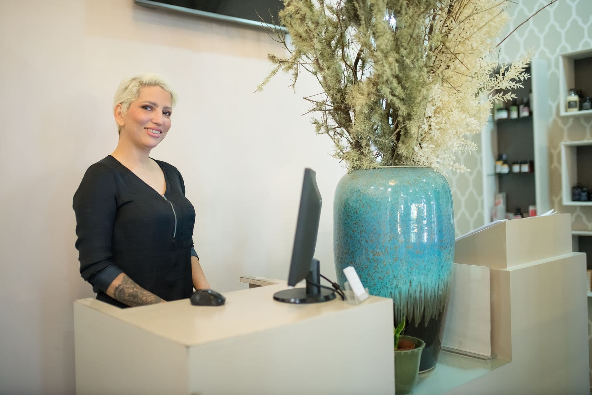 A receptionist at a salon front desk