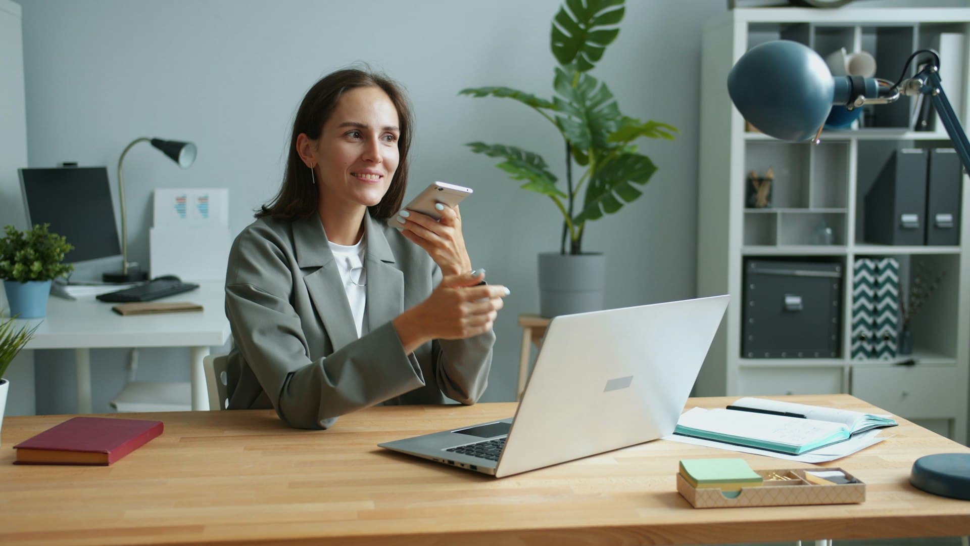 An office manager books jobs by phone at her desk