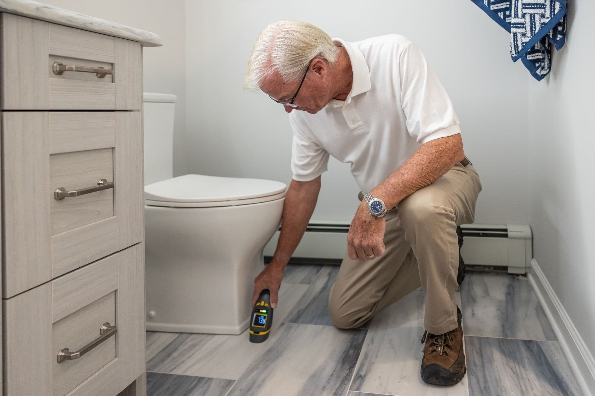 A technician checks a bathroom on a service visit